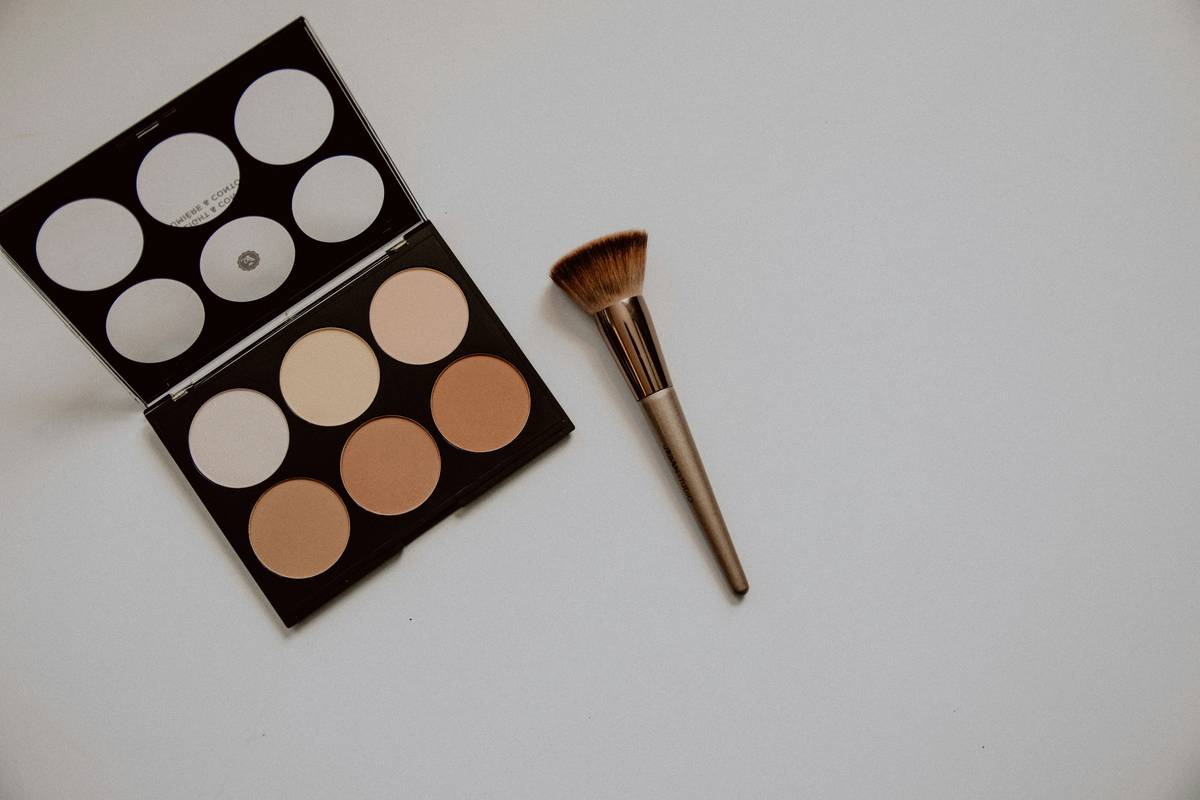 Professional applying brow gel with a cosmetic precision tool for defined arches